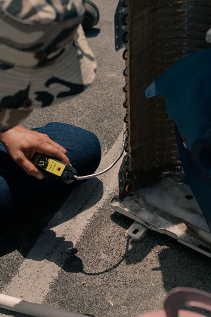 A technician testing an AC coil with a multimeter